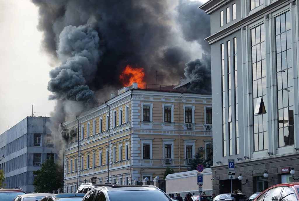 Emergency workers operating outside the damaged National Academy of Sciences building following a drone strike in Kyiv