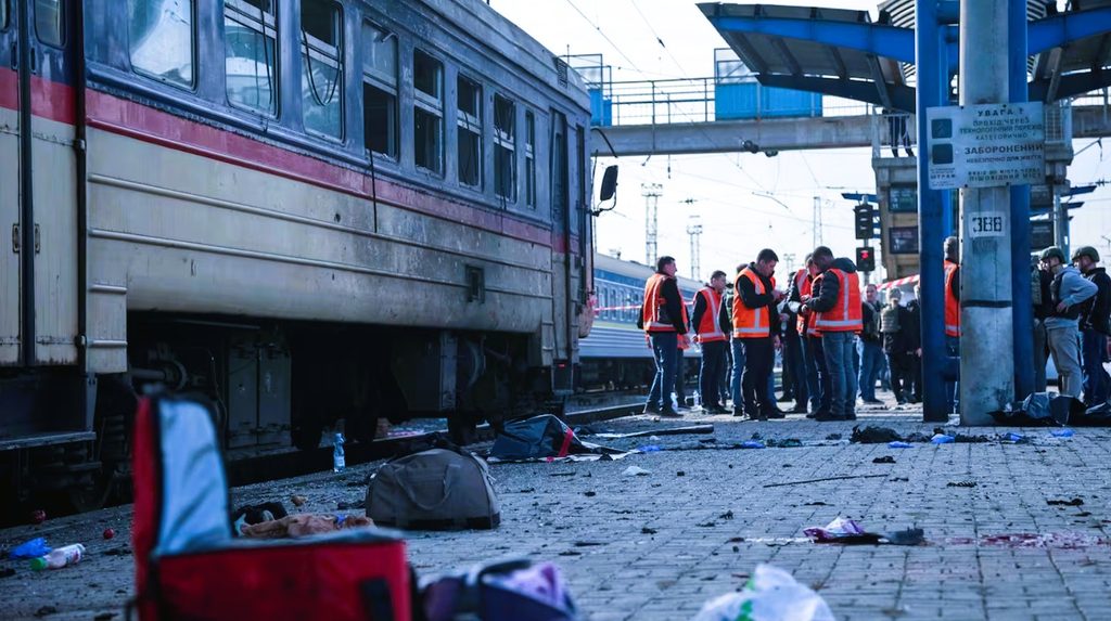 Emergency rescue teams evacuating wounded civilians at Dnipro railway station platform following Russian drone strike