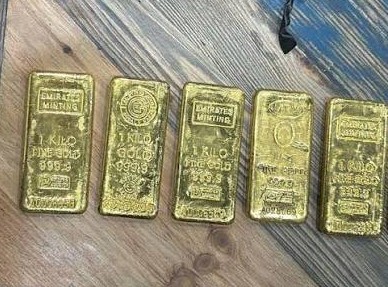 Kathmandu Valley Crime Investigation Office officers inspecting 21 kg of seized gold in Teku