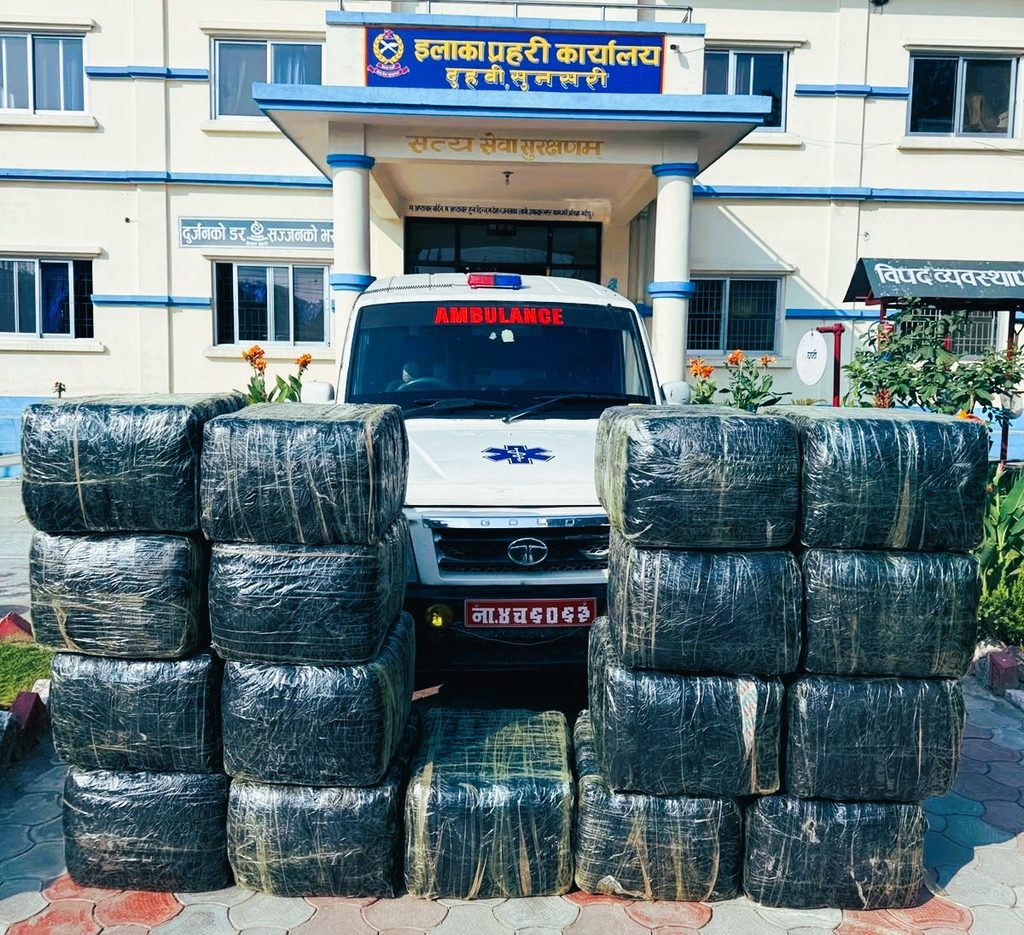 Sunsari Police displaying seized sacks of marijuana alongside the impounded ambulance in Duhabi