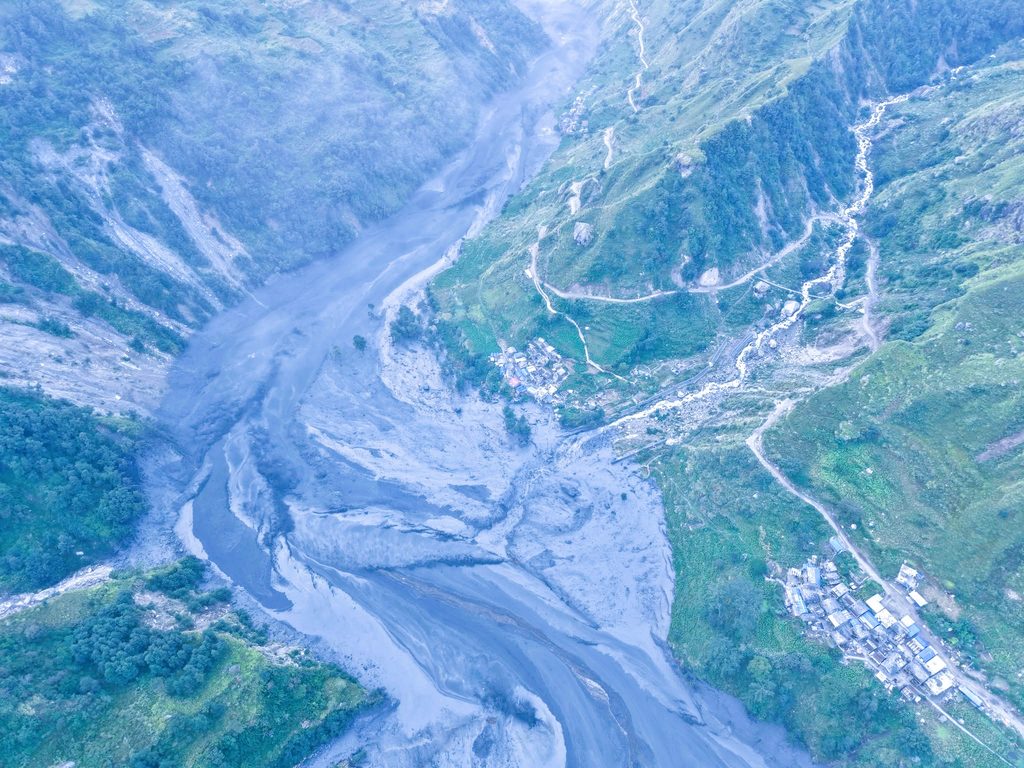 Aerial view of the black mud-laden Budhi Gandaki River flowing through damaged terrain in northern Gorkha following a landslide disaster