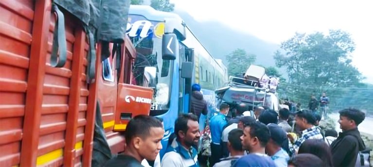Nepal Police clearing a multi-vehicle accident site involving a bus and truck on Prithvi Highway in Chitwan