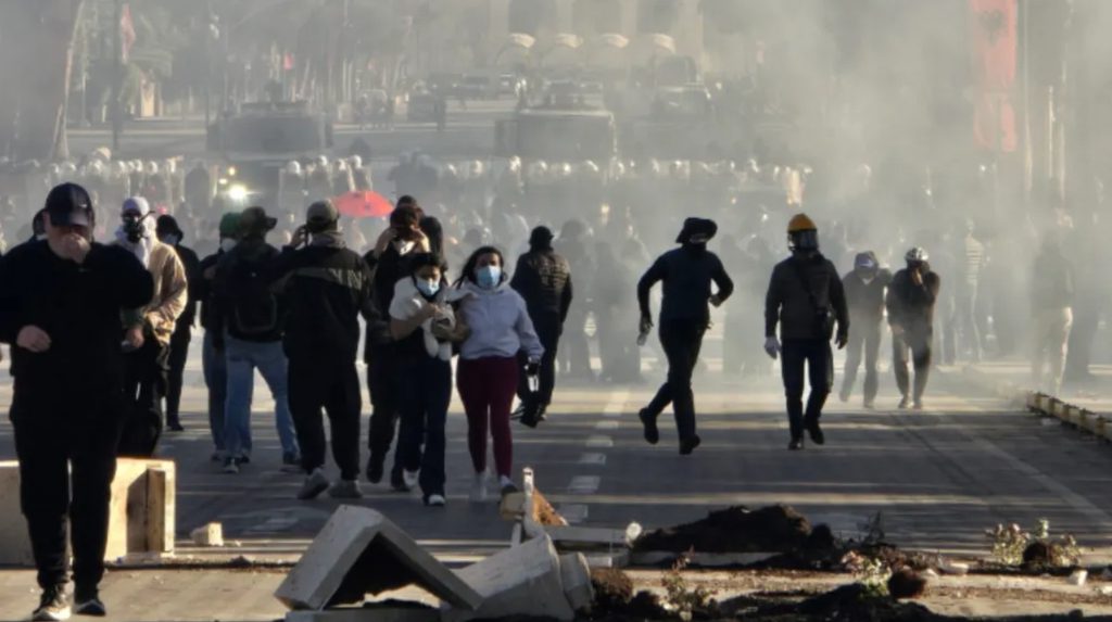 Riot police using water cannons and tear gas against anti-government demonstrators near the Education Ministry in Tirana, Albania