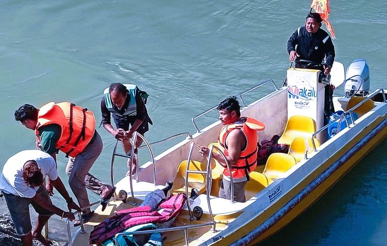 Nepal Police and Armed Police Force personnel conducting search and rescue operations on the Saptakoshi River