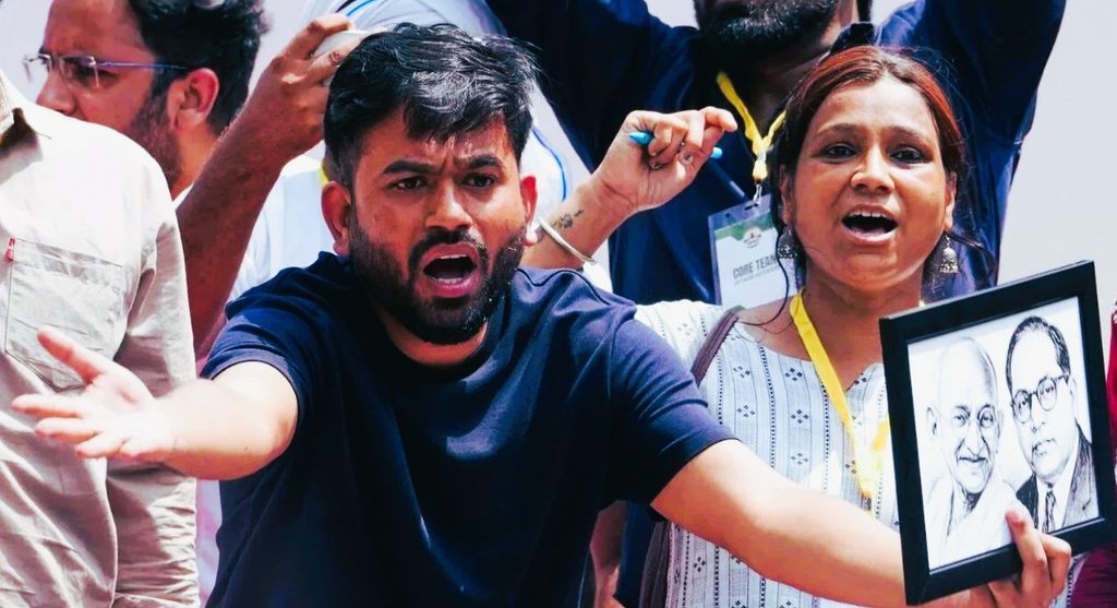 Delhi Police personnel detaining Cockroach Janta Party founder Abhijeet Dipke in central New Delhi during an anti-government demonstration