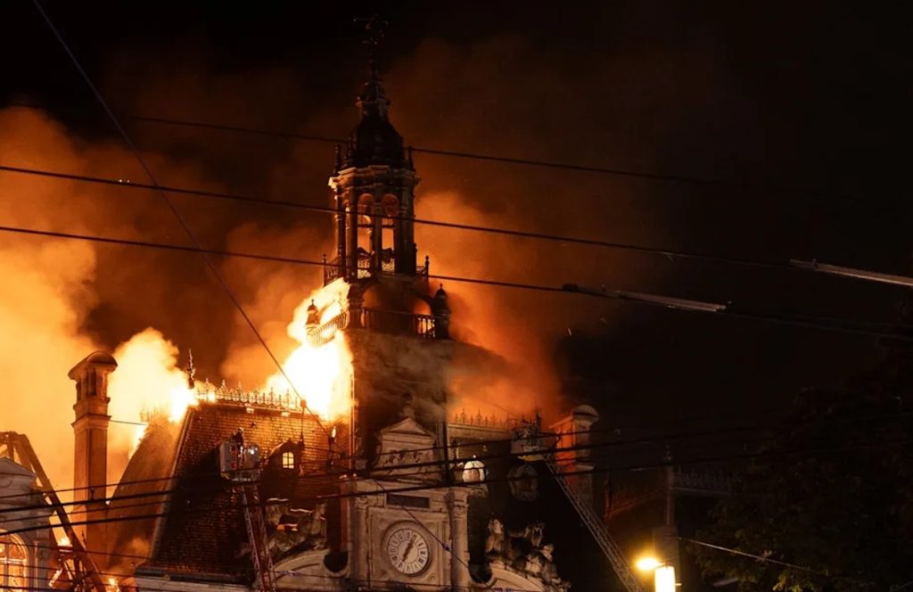 French emergency services and police cordons surrounding the fire-damaged historic Town Hall of Limoges following overnight arson