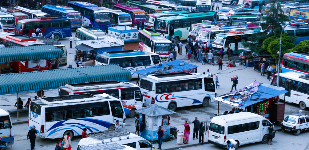 Crowded Gongabu New Bus Park in Kathmandu with long-distance passenger buses preparing for Dashain travel