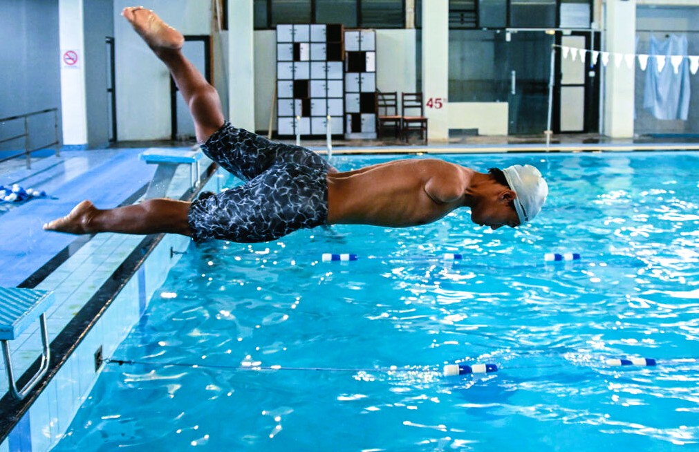 Nepali para swimmer Harka Man Gharti celebrating in the pool after qualifying for the 50m freestyle S5 final at the Asian Para Games in Japan