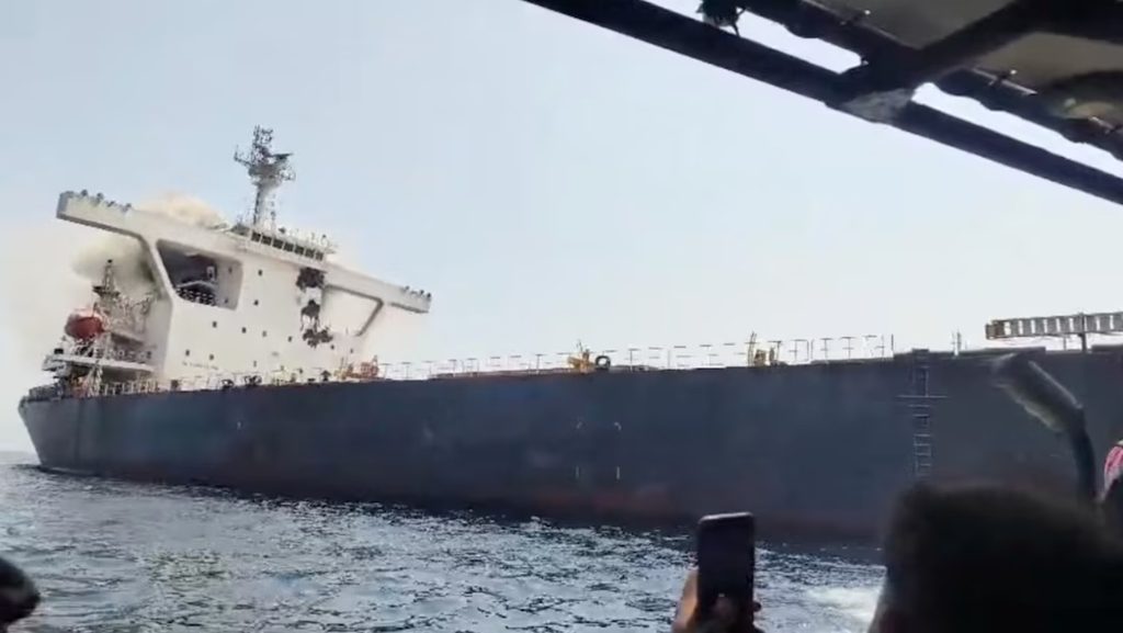 Commercial container vessel transiting the Strait of Hormuz under heavy security monitoring amid regional maritime attacks