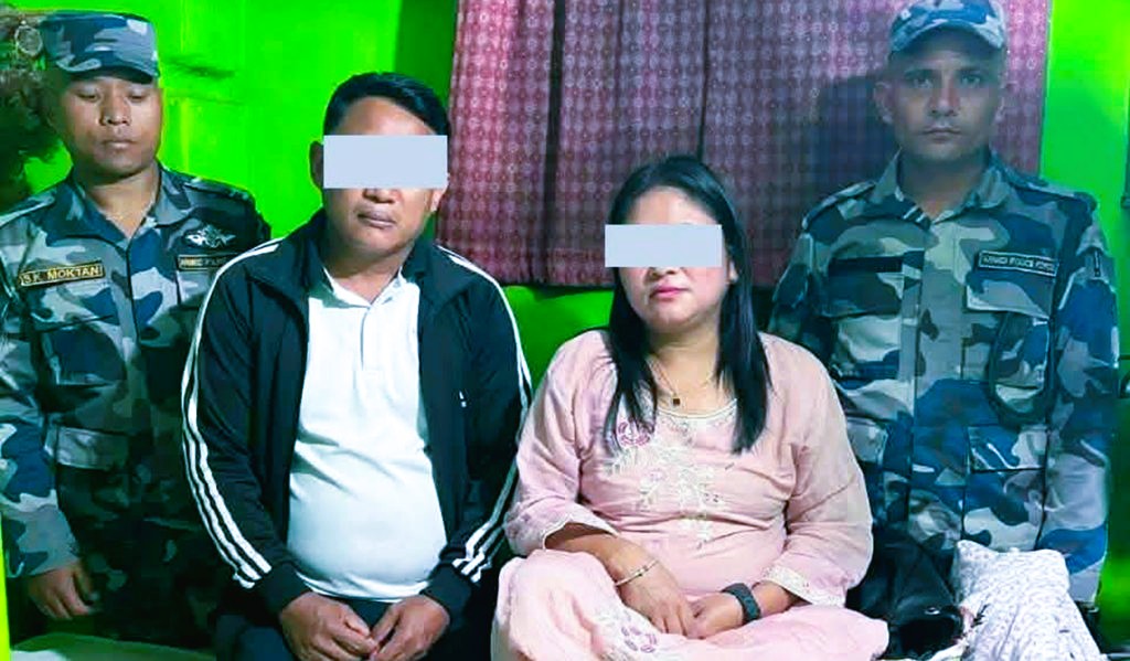 Armed Police Force officers standing near seized contraband and evidence inside a Kathmandu guest house