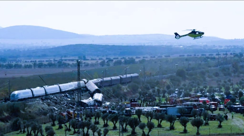Emergency rescue teams working around derailed passenger train carriages following high-speed rail crash in Urda Spain